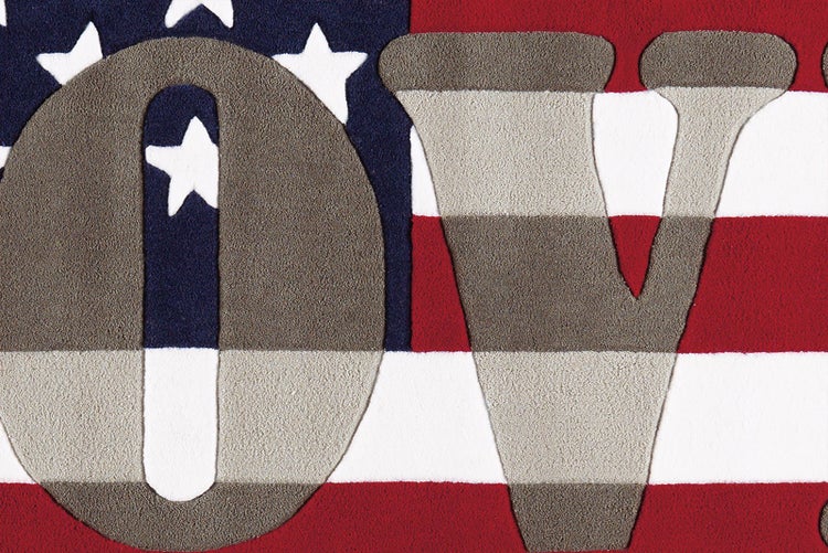 Detail koberce s designem americké vlajky a písmeny O a V.
