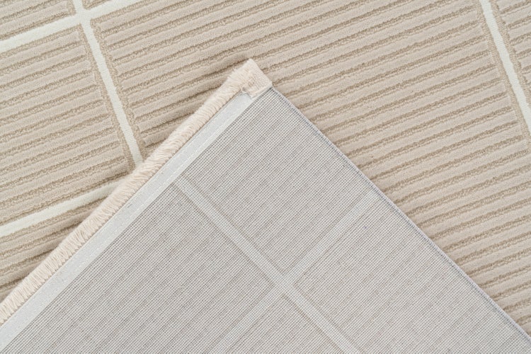Detailní pohled na koberec s pruhovaným tkaným vzorem a strukturovanou zadní stranou z tkaniny.