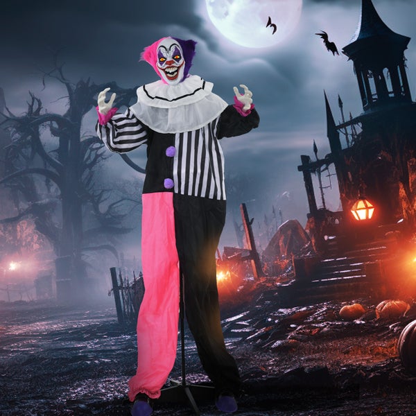 Animovaný hororový klaun jako halloweenská dekorace před kulisou hřbitova