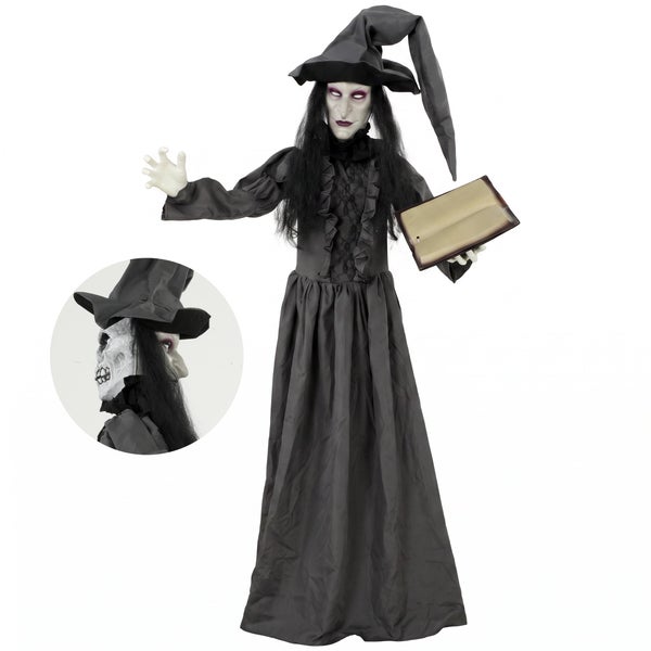 Animovaná halloweenská čarodějnice s knihou v šatech až na zem a špičatým kloboukem jako dekorativní halloweenská figurka.