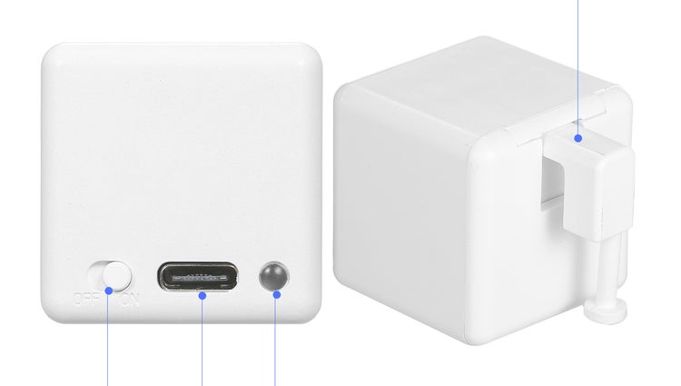 Bílý senzor ve tvaru kostky s vypínačem, USB nabíjecím portem, kontrolkou a výklopným háčkem pro upevnění.