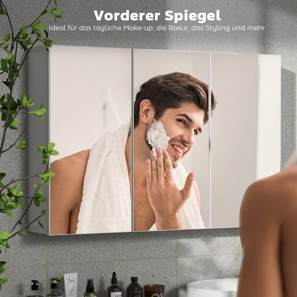 Třídveřová zrcadlová skříňka nad umyvadlem v koupelně s mužem, který se holí, pro každodenní osobní hygienu.