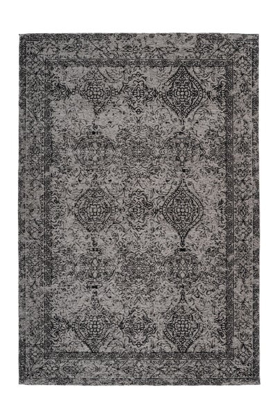 Obdélníkový koberec s orientálním vzorem a ornamenty ve vintage stylu.
