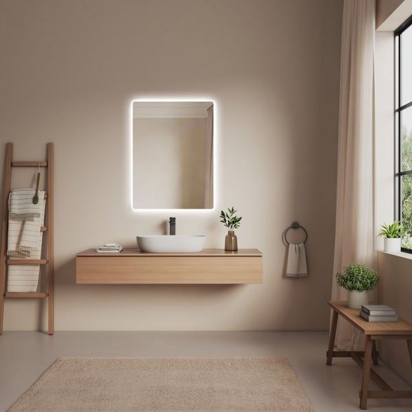 Moderní koupelna s dřevěnou skříňkou pod umyvadlo, umyvadlem na desku a obdélníkovým LED zrcadlem ve světlém, minimalistickém designu.